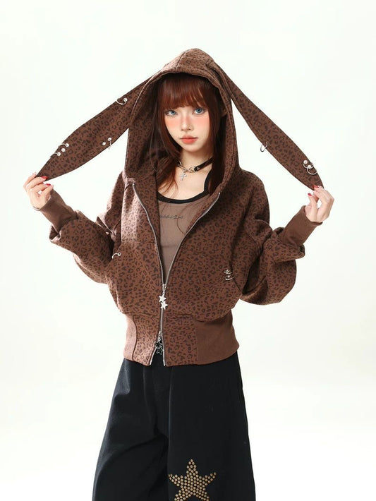 Person wearing a brown hoodie with bunny ears on a white background