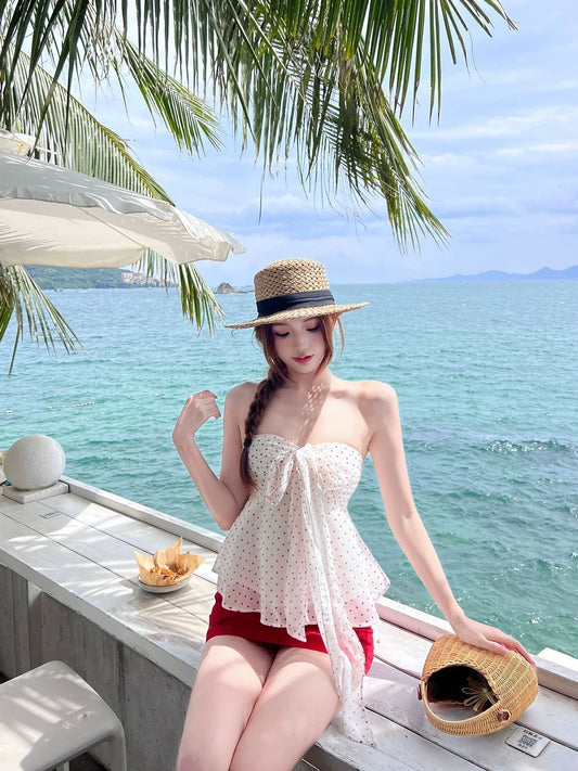 INNA Saint-Tropez white polka-dot tankini top with front bow at the seaside
